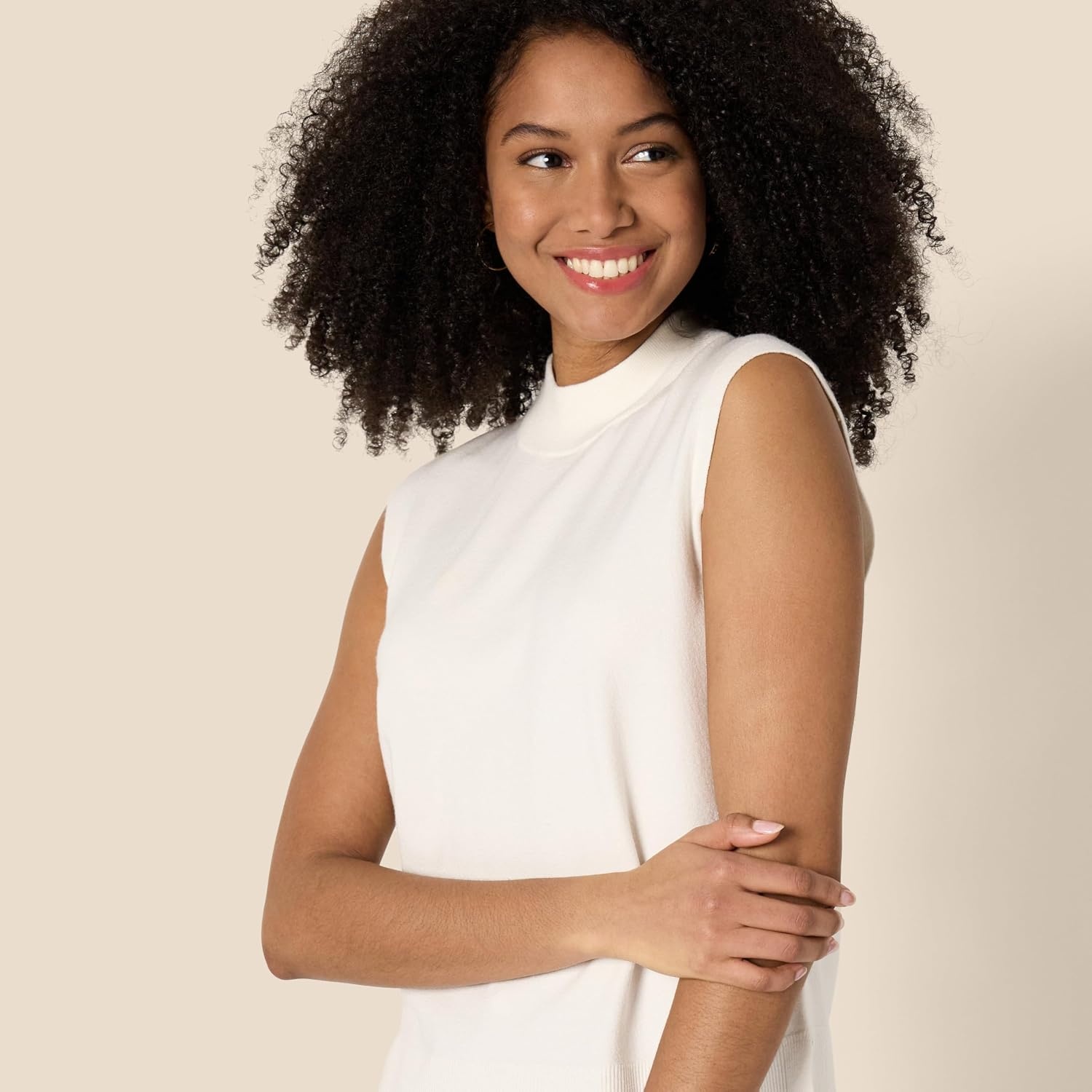 image:imageAmazon Essentials Womens RegularFit Cap Sleeve Mock Neck Sweater TopEggshell White