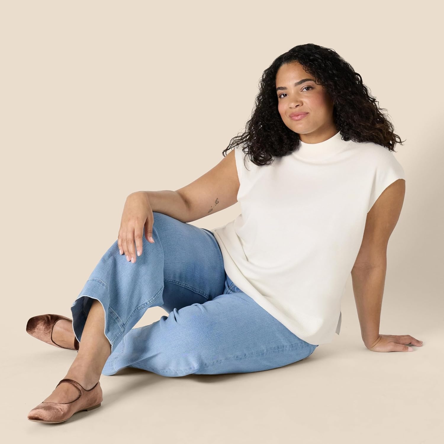 image:imageAmazon Essentials Womens RegularFit Cap Sleeve Mock Neck Sweater TopEggshell White